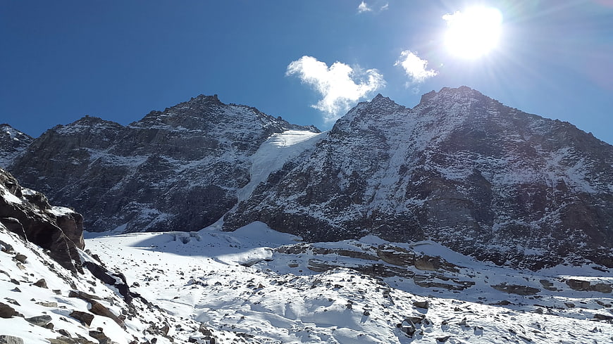 Snowy Mountain Peaks Under Bright Sun