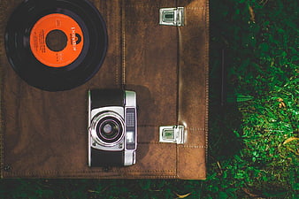 Vintage Camera and Vinyl Record on Leather Briefcase