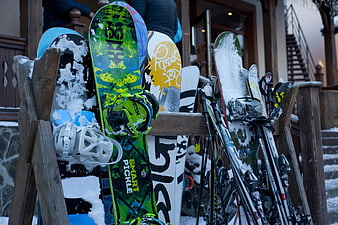 Snowboards and Skis in Wooden Rack at Ski Resort