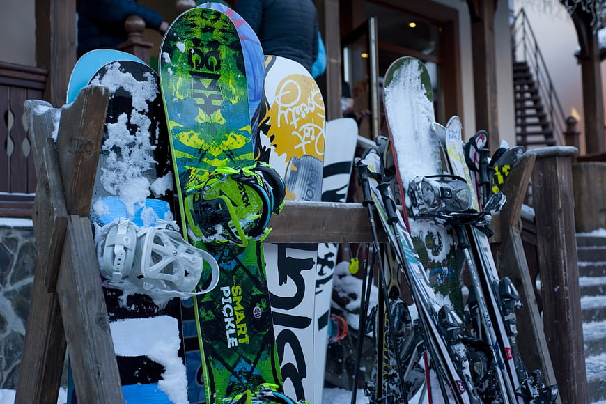 Snowboards and Skis in Wooden Rack at Ski Resort