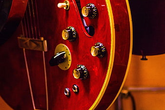 Close-up of Red Electric Guitar Body and Knobs