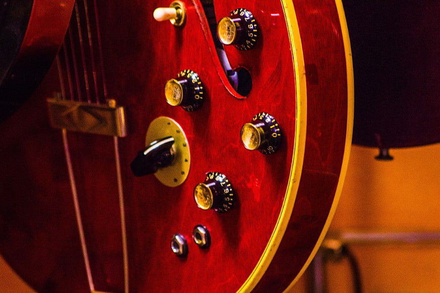 Close-up of Red Electric Guitar Body and Knobs