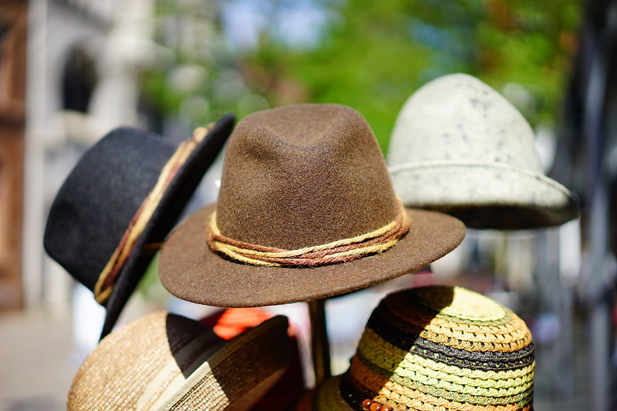 Colorful felt and straw hats on display stand