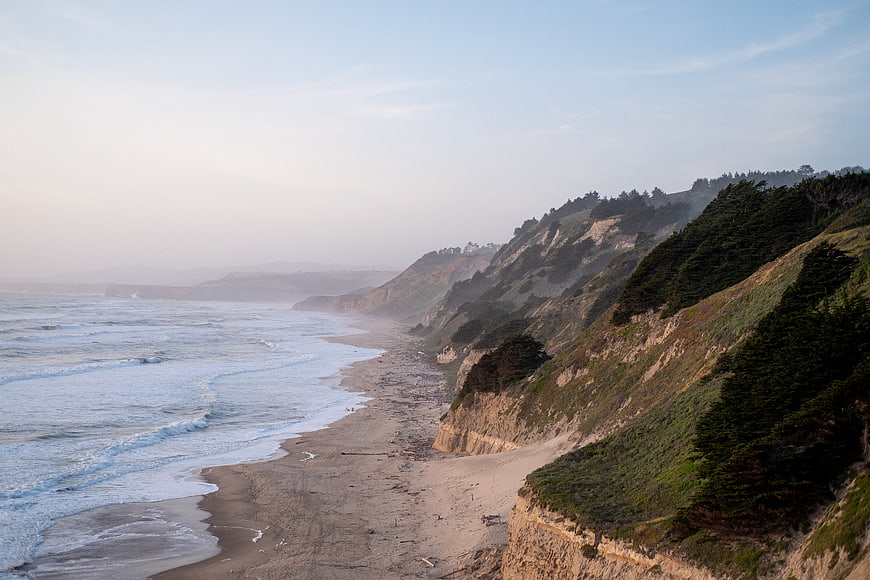 Misty Pacific Coastline with Cliffs and Ocean Waves