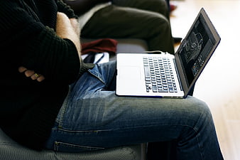 Man with Laptop on Lap Working on 3D Model