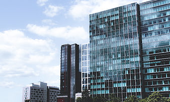 Modern Glass Office Buildings Against Blue Sky
