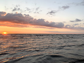 Serene Ocean Sunset with Golden Sun and Clouds