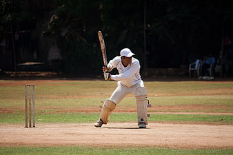 Cricket Batsman Playing Defensive Shot On Outdoor Pitch