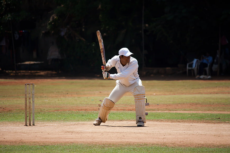 Cricket Batsman Playing Defensive Shot On Outdoor Pitch