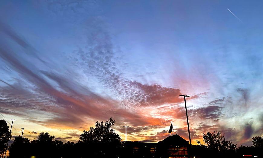 Vibrant Sunset Sky with Textured Clouds and Silhouette