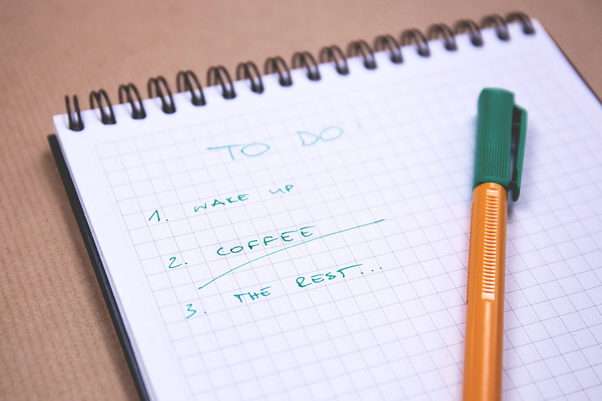 Handwritten To-Do List on Grid Notebook with Pen