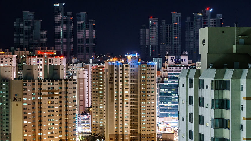 Night cityscape of dense urban apartment buildings and skyscrapers