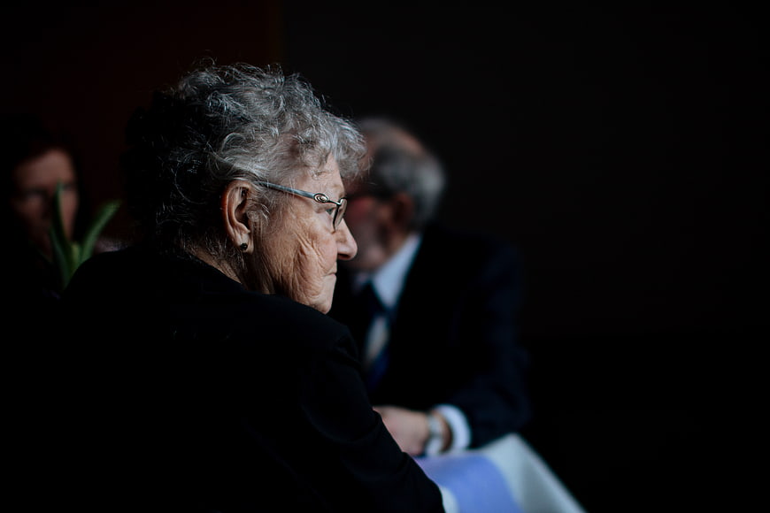 Senior Woman in Profile at Formal Event