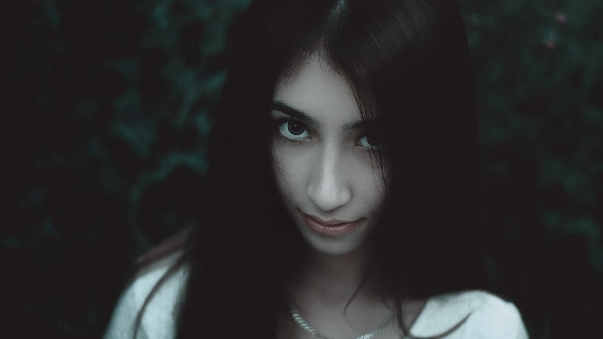 Moody Portrait of Woman with Dark Hair and Silver Necklace