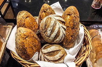 Fresh artisan bread loaves in a wicker basket