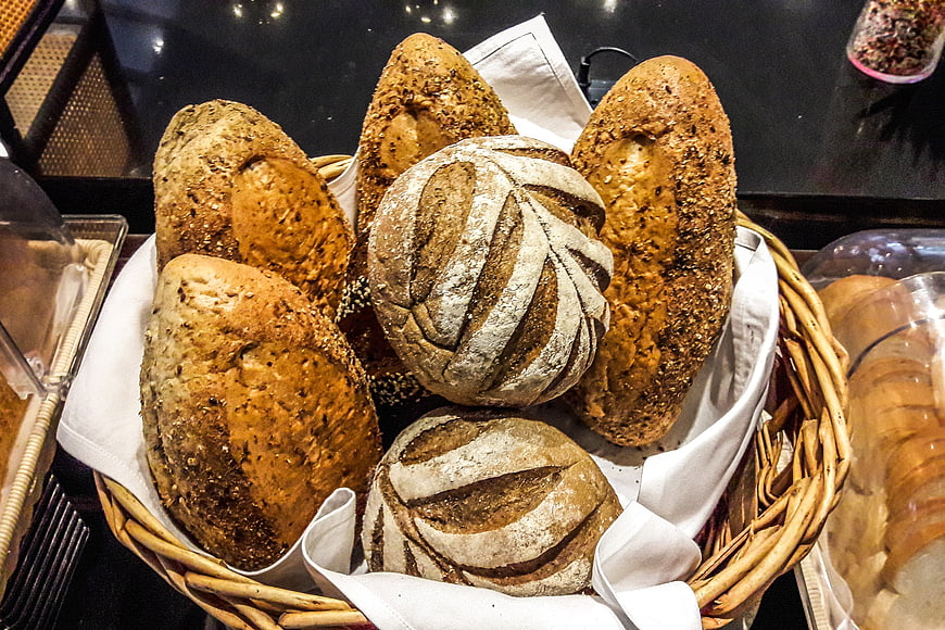 Fresh artisan bread loaves in a wicker basket