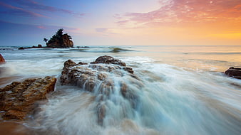 Long Exposure Sunset Ocean Waves Crashing on Rocky Coastline