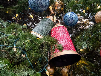 Red and Green Christmas Bell Ornaments on Pine Tree