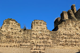 Ancient Stone Castle Ruins Against Blue Sky