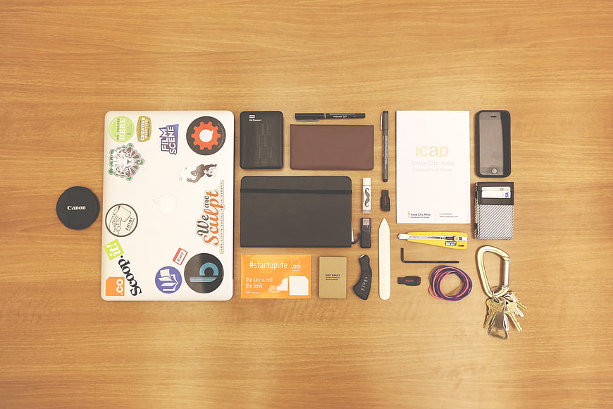 Flat lay of startup workspace essentials on wooden desk