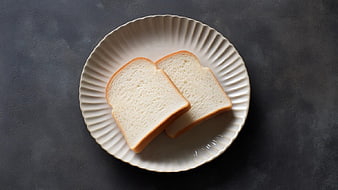 Two Slices of White Bread on a Fluted Ceramic Plate