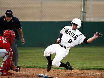 Baseball Player Sliding into Home Plate During Game