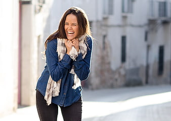 Young Woman Laughing Joyfully In Urban Street Setting