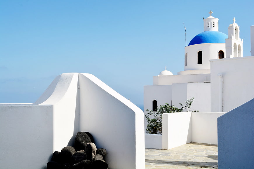 White Cycladic Church with Blue Dome Against Clear Sky