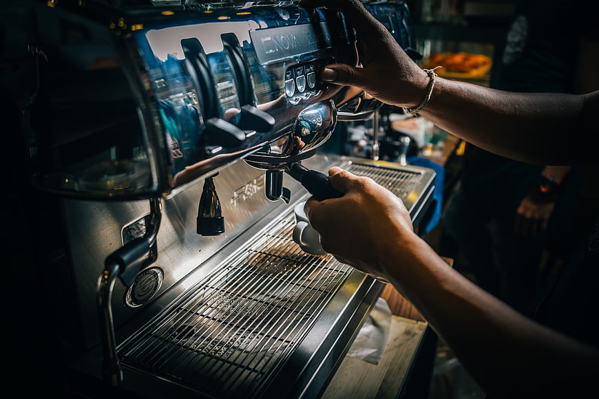 Barista Hands Operating Espresso Machine in Coffee Shop