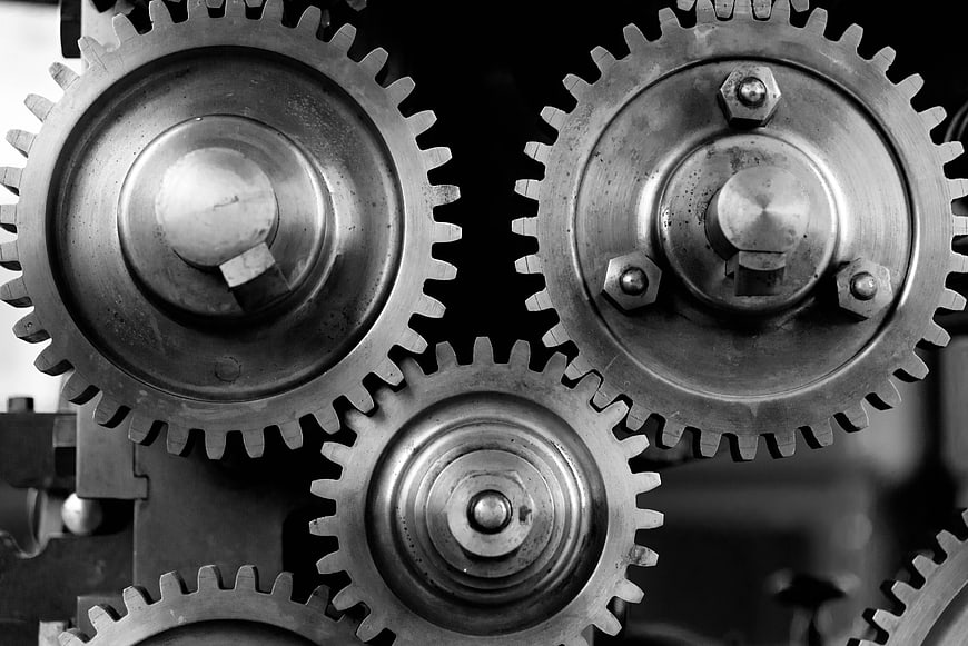 Close-up of interlocking metal gears in black and white