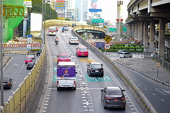 Busy Bangkok Highway Traffic with Taxis and Elevated Expressway