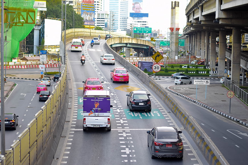 Busy Bangkok Highway Traffic with Taxis and Elevated Expressway