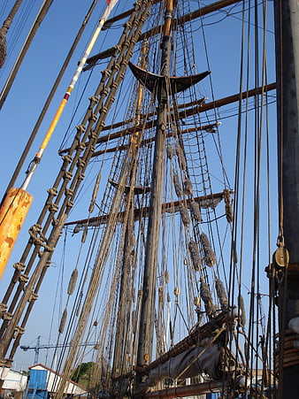 Detailed view of tall ship rigging against blue sky