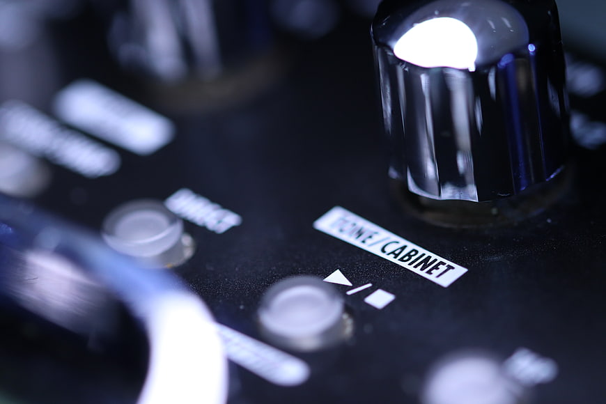 Close-up of guitar amplifier knobs and controls