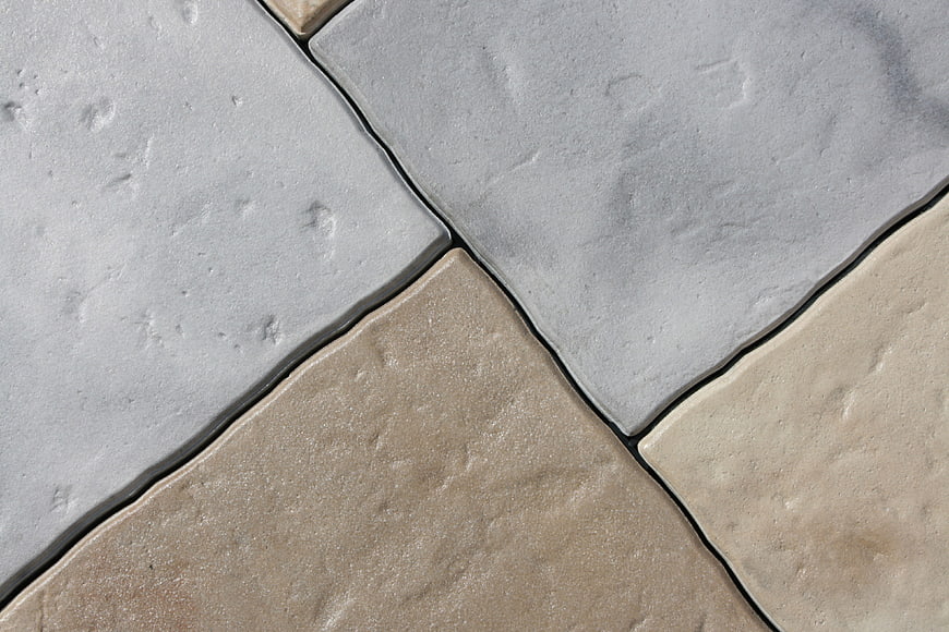 Close-up of gray and beige stone tiles with dark grout lines