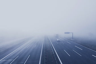 Foggy Highway with Cars Driving in Low Visibility