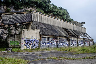 Abandoned industrial building with graffiti on concrete walls