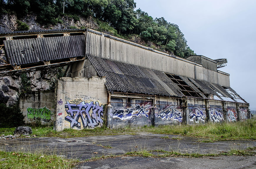 Abandoned industrial building with graffiti on concrete walls