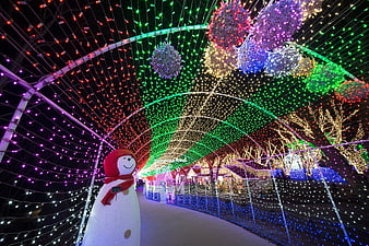 Colorful Christmas Light Tunnel With Snowman At Night