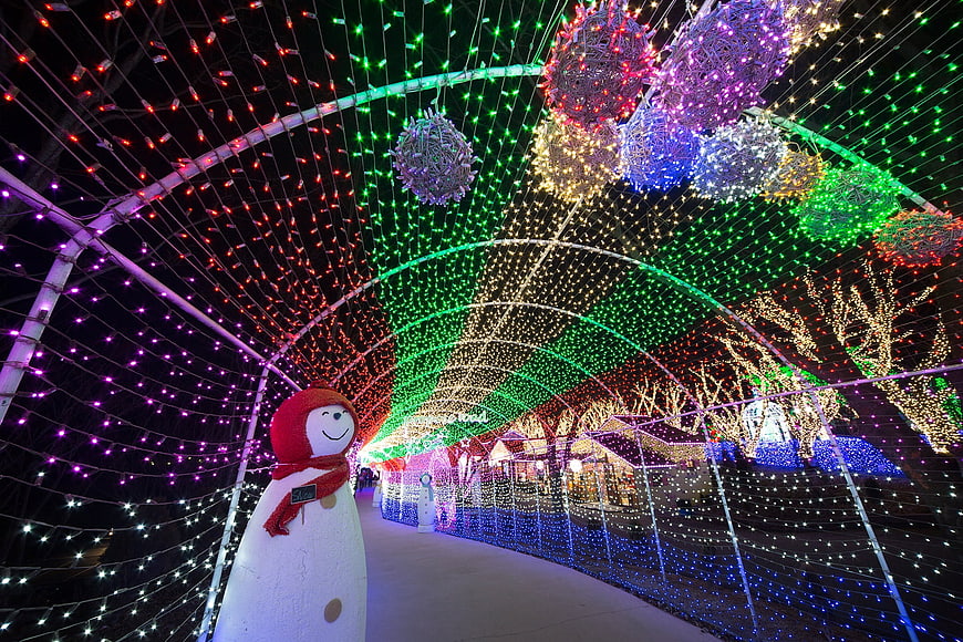 Colorful Christmas Light Tunnel With Snowman At Night