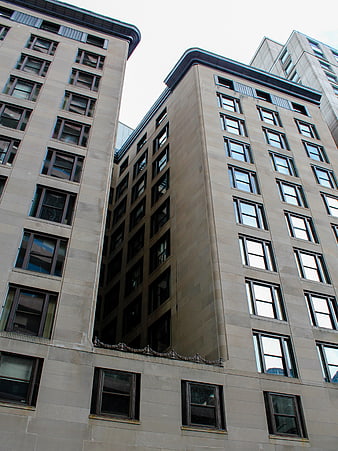 Low angle view of modern beige stone office buildings
