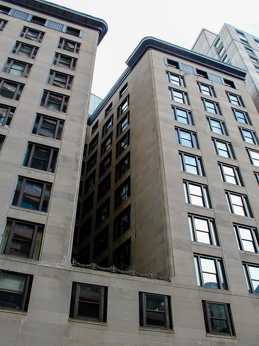 Low angle view of modern beige stone office buildings