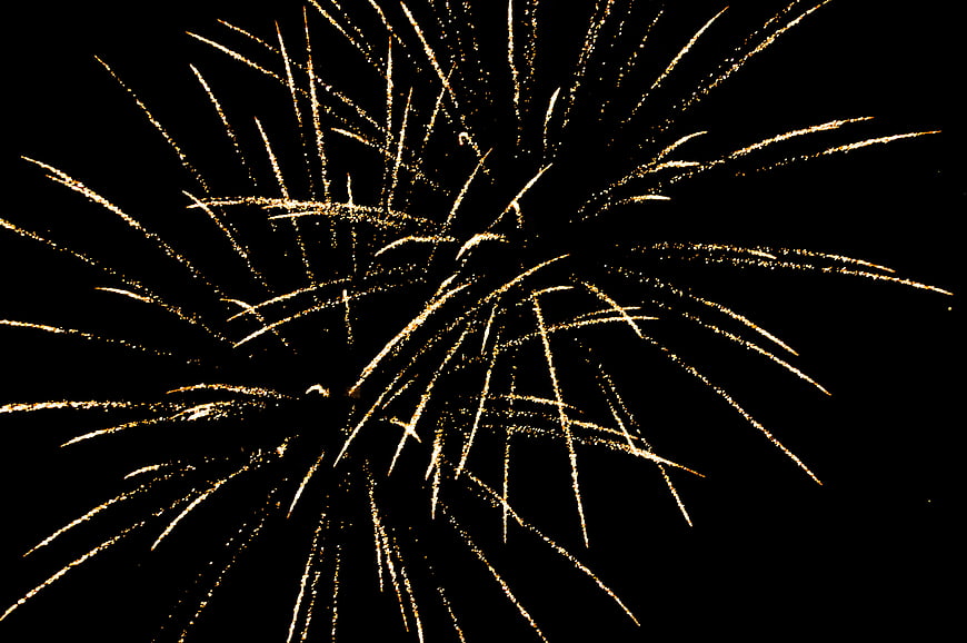 Golden Fireworks Bursting Against Black Night Sky