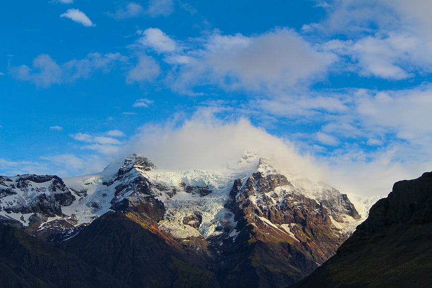 Majestic Snow-Capped Mountain Peak with Clouds