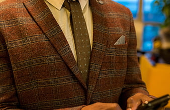 Man in Tweed Suit and Tie Using Smartphone