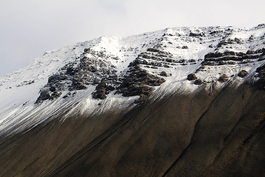 Snowy Mountain Slope with Dark Rocky Terrain
