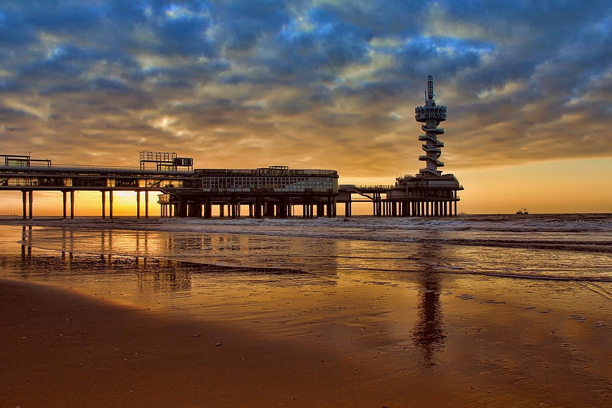 Brighton Palace Pier at Sunset with Golden Sky and Reflections