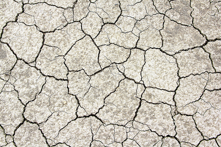 Close-up of cracked dry earth texture background