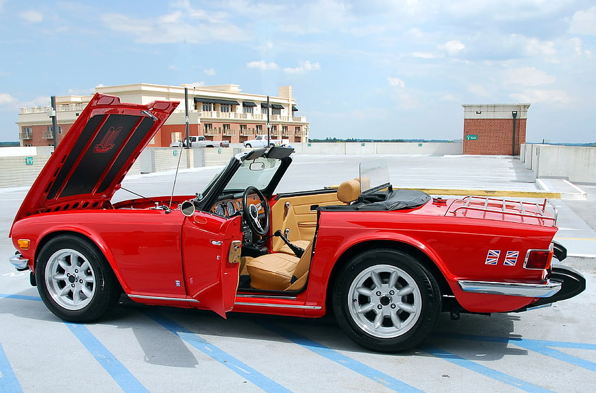 Red Classic Convertible with Open Hood on Rooftop Parking