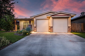 Modern suburban home exterior with double garage at twilight